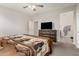 Bedroom with ceiling fan, dresser with television, and carpeted floor at 12357 W Whyman Ave, Avondale, AZ 85323