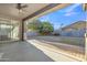Back patio with ceiling fan, brick trim, and view of landscaped backyard at 1258 W Plane Tree Ave, San Tan Valley, AZ 85140