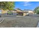 Spacious backyard with a covered patio and block wall, perfect for entertaining at 1258 W Plane Tree Ave, San Tan Valley, AZ 85140