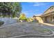 Generous backyard with mature trees and partial lawn area at 1258 W Plane Tree Ave, San Tan Valley, AZ 85140