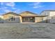 Rear exterior view showcasing a large, flat yard with grass and landscaping at 1258 W Plane Tree Ave, San Tan Valley, AZ 85140