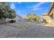 Spacious backyard featuring gravel and a grass patch area at 1258 W Plane Tree Ave, San Tan Valley, AZ 85140