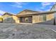 Rear exterior view of the home highlighting covered patio, windows and neutral color at 1258 W Plane Tree Ave, San Tan Valley, AZ 85140