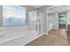Bright bathroom with a soaking tub, and a glass enclosed walk-in shower and tile floors at 1258 W Plane Tree Ave, San Tan Valley, AZ 85140