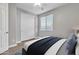 Simple bedroom with a closet, window, and minimalistic design for a clean, modern look at 1258 W Plane Tree Ave, San Tan Valley, AZ 85140