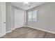 Bright bedroom featuring wood-look flooring and a ceiling fan at 1258 W Plane Tree Ave, San Tan Valley, AZ 85140