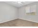 Clean, carpeted bedroom featuring a ceiling fan, window, and neutral paint at 1258 W Plane Tree Ave, San Tan Valley, AZ 85140