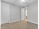 Spacious, carpeted bedroom featuring two doors, a ceiling fan, and neutral paint at 1258 W Plane Tree Ave, San Tan Valley, AZ 85140