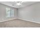 Spacious bedroom featuring neutral carpet, large window, and a ceiling fan at 1258 W Plane Tree Ave, San Tan Valley, AZ 85140