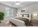 Cozy bedroom featuring a large window and decorative artwork, creating a peaceful ambiance at 1258 W Plane Tree Ave, San Tan Valley, AZ 85140