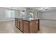 Bright kitchen with granite island, stainless dishwasher, and open layout to the dining and living rooms at 1258 W Plane Tree Ave, San Tan Valley, AZ 85140