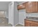 Kitchen area with modern cabinets, granite countertops, and access to laundry hookups at 1258 W Plane Tree Ave, San Tan Valley, AZ 85140