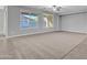 Bright living area filled with natural light featuring neutral carpet and window views at 1258 W Plane Tree Ave, San Tan Valley, AZ 85140