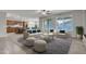 Open-concept living room featuring neutral furnishings and an adjacent kitchen with breakfast bar seating at 1258 W Plane Tree Ave, San Tan Valley, AZ 85140