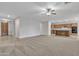 Spacious living area with carpet flooring and a view of the open kitchen at 1258 W Plane Tree Ave, San Tan Valley, AZ 85140