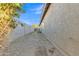 Narrow side yard with gravel landscaping and block wall, providing low-maintenance outdoor space at 1258 W Plane Tree Ave, San Tan Valley, AZ 85140
