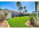 Bright backyard features lush artificial grass, a storage shed and elegant landscaping at 13233 W Mauna Loa Ln, Surprise, AZ 85379