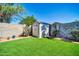 This backyard features low-maintenance artificial grass and a convenient storage shed at 13233 W Mauna Loa Ln, Surprise, AZ 85379