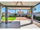 View of covered backyard patio that overlooks the yard and brick features at 13233 W Mauna Loa Ln, Surprise, AZ 85379