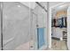 Modern bathroom featuring a glass-enclosed shower with marble tiling and a built-in bench at 13233 W Mauna Loa Ln, Surprise, AZ 85379