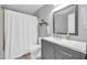 This bathroom offers a shower, vanity, sink, and updated mirror at 13233 W Mauna Loa Ln, Surprise, AZ 85379