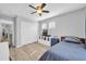 Cozy bedroom with a ceiling fan, two windows, closet and simple decor with carpet floors at 13233 W Mauna Loa Ln, Surprise, AZ 85379