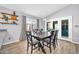 Well-lit dining space featuring wood-look floors, modern lighting, and convenient access to the backyard at 13233 W Mauna Loa Ln, Surprise, AZ 85379