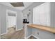 Hallway leads to other rooms featuring light gray walls and laminate floors at 13233 W Mauna Loa Ln, Surprise, AZ 85379