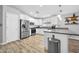 Bright kitchen featuring stainless steel appliances, white cabinetry, granite countertops, and pendant lighting at 13233 W Mauna Loa Ln, Surprise, AZ 85379