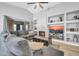 Spacious living room with a vaulted ceiling, a fireplace, and a large sectional sofa at 13233 W Mauna Loa Ln, Surprise, AZ 85379