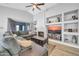 Comfortable living room showcasing a fireplace, built-in shelves, and sliding doors to the outdoor space at 13233 W Mauna Loa Ln, Surprise, AZ 85379
