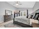 The main bedroom features light gray walls, light wood flooring, and backyard access at 13233 W Mauna Loa Ln, Surprise, AZ 85379
