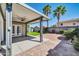 This backyard offers a covered patio, manicured lawn, and brick-paved area at 13233 W Mauna Loa Ln, Surprise, AZ 85379