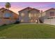 The backyard offers a grassy area, privacy fence, and mature landscaping at 1433 E Mineral Rd, Gilbert, AZ 85234