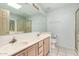 Bathroom featuring double sinks, a large mirror, and a glass door shower at 1433 E Mineral Rd, Gilbert, AZ 85234