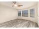 Bright bedroom with hardwood floors, ceiling fan, and large windows at 1433 E Mineral Rd, Gilbert, AZ 85234