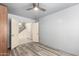 Comfortable bedroom features gray vinyl plank flooring, closet and ensuite access at 1433 E Mineral Rd, Gilbert, AZ 85234