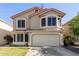 Two-story home with attached garage, tiled roof, arched windows, and established lawn at 1433 E Mineral Rd, Gilbert, AZ 85234