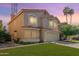 Inviting two-story home featuring a well-manicured lawn and desert landscaping under a vivid sky at 1433 E Mineral Rd, Gilbert, AZ 85234