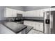 Kitchen featuring stainless steel refrigerator, white cabinets and stone countertops at 1433 E Mineral Rd, Gilbert, AZ 85234