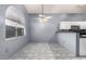 Cozy eat-in kitchen boasts tile flooring, arched window, and white cabinets at 1433 E Mineral Rd, Gilbert, AZ 85234