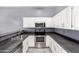 Updated kitchen features stainless steel appliances and neutral color palette at 1433 E Mineral Rd, Gilbert, AZ 85234