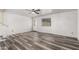 Bright living room with modern gray vinyl plank flooring and a white front door at 1433 E Mineral Rd, Gilbert, AZ 85234