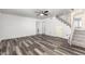 Open-concept living space features durable gray vinyl plank flooring and carpeted stairs at 1433 E Mineral Rd, Gilbert, AZ 85234