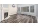 Living room with fireplace, big windows and durable gray vinyl plank flooring at 1433 E Mineral Rd, Gilbert, AZ 85234
