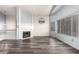 Comfortable living room with fireplace, multiple windows and updated floors at 1433 E Mineral Rd, Gilbert, AZ 85234