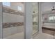 Modern bathroom showcasing a tiled walk-in shower with glass enclosure, and connection to the main bedroom at 14571 W Wethersfield Rd, Surprise, AZ 85379