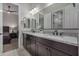 Bathroom featuring double vanity, granite countertops and views to bedroom and shower with white subway tile at 14571 W Wethersfield Rd, Surprise, AZ 85379