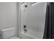 Bathroom featuring white subway tile in the shower and a window allowing for plenty of natural light at 14571 W Wethersfield Rd, Surprise, AZ 85379