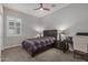 Cozy bedroom with a single bed, window with shutters, and a desk area for study or work at 14571 W Wethersfield Rd, Surprise, AZ 85379
